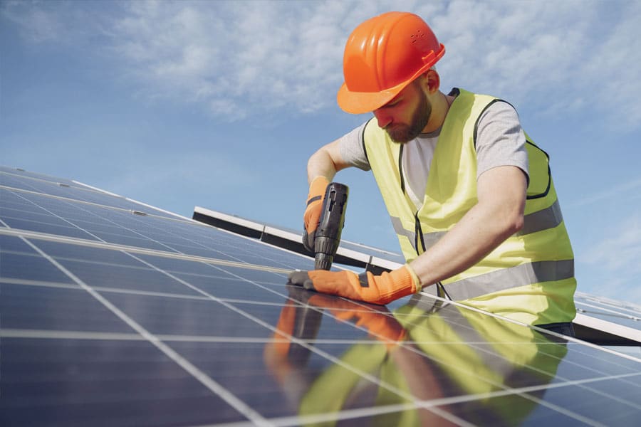 A REF renewable energy electrician installing solar panels