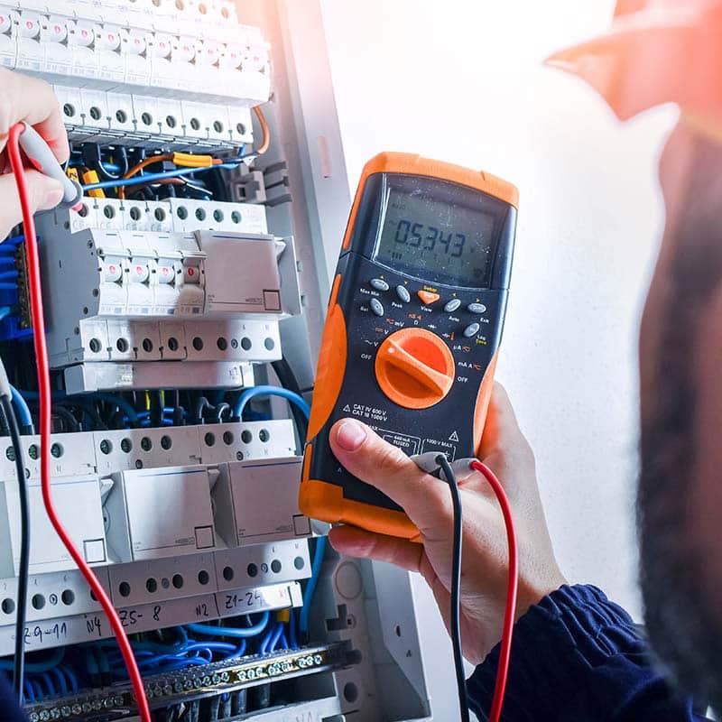 An electrician checking and maintaining